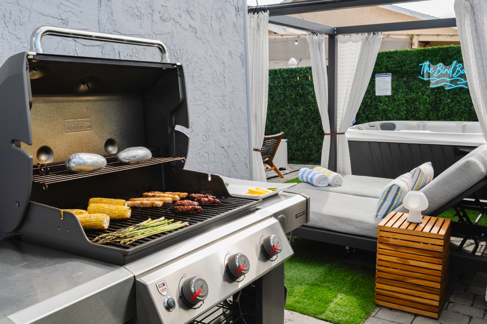 Weber barbecue grill beside the hot tub and cabana