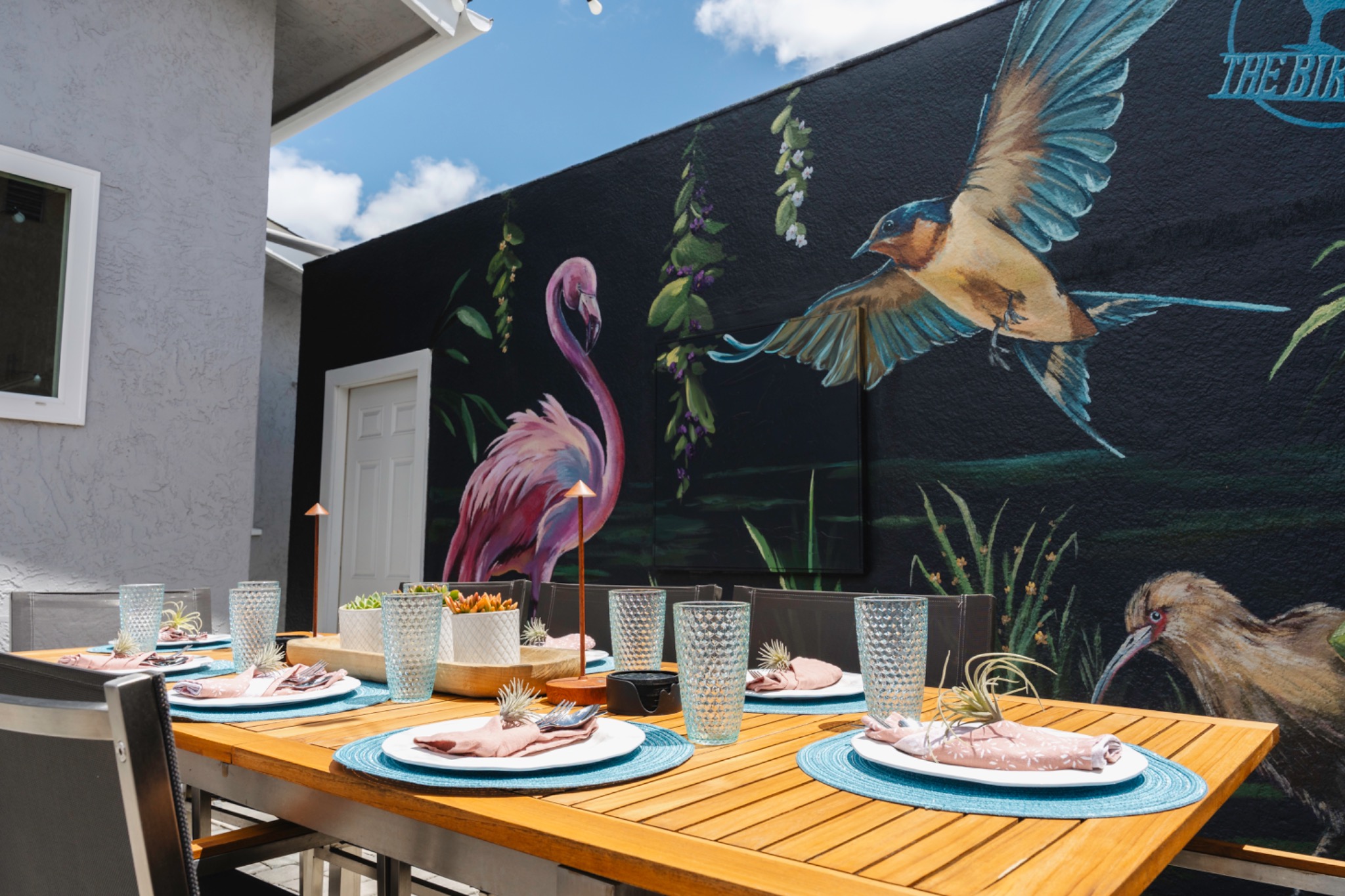 Birdhouse backyard mural wall and outdoor dining